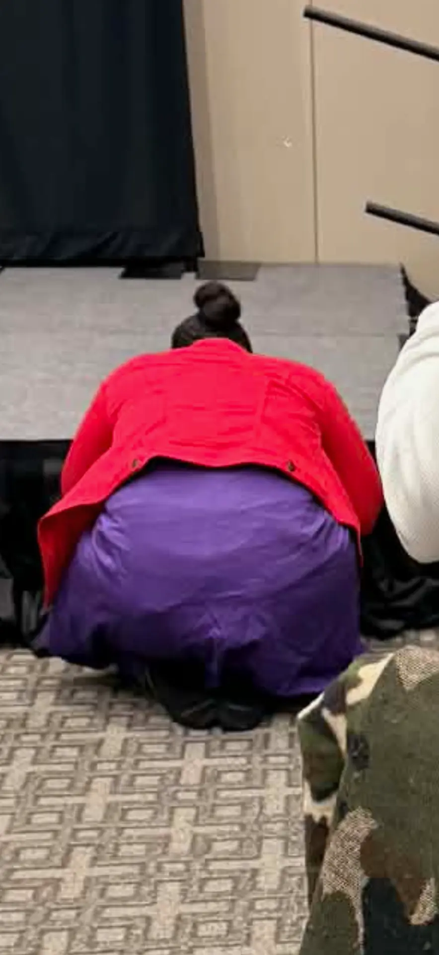 Coach WyKehlia kneeling in prayer